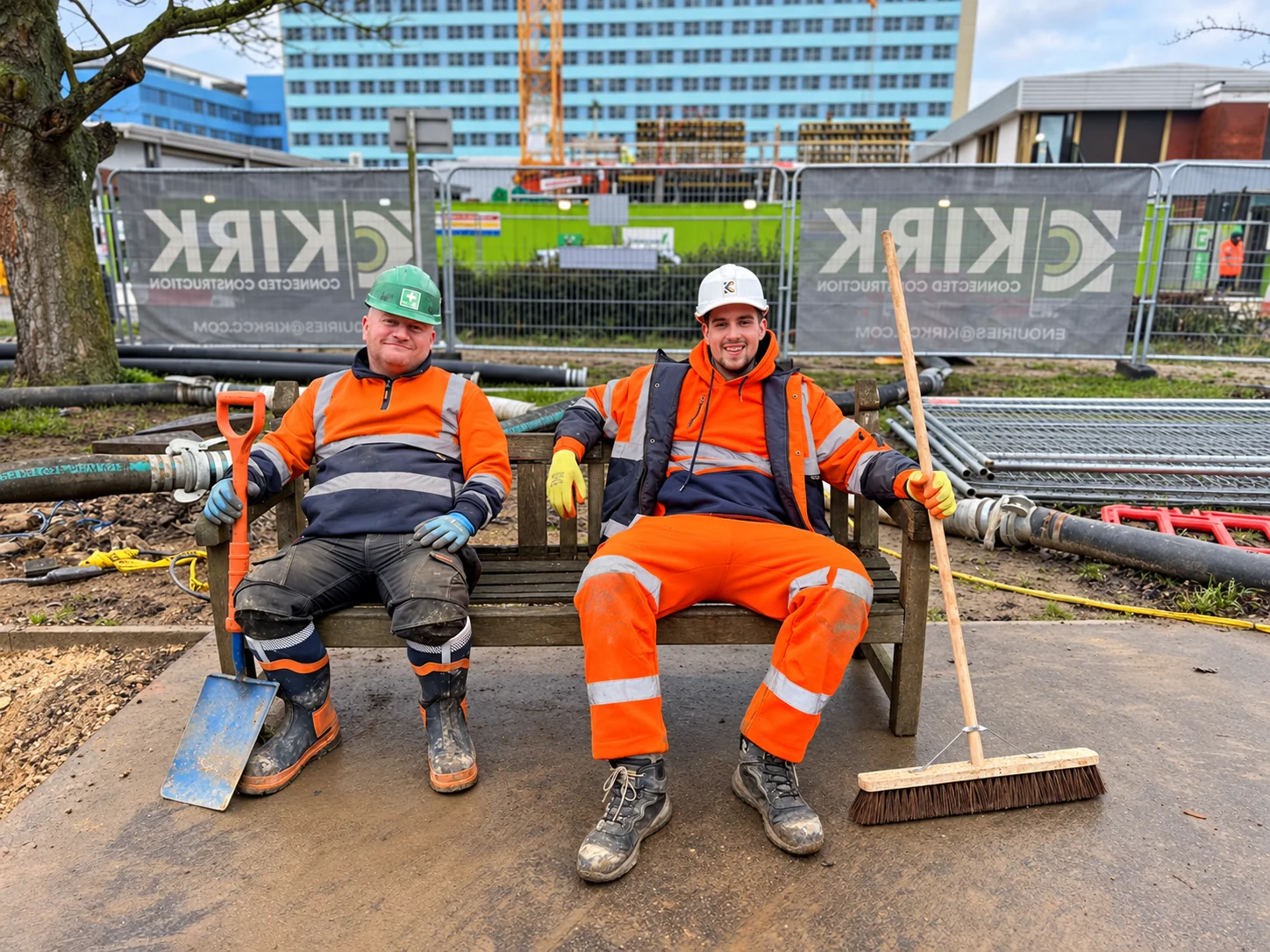 Two Kirk Connected Construction team members seated together on site