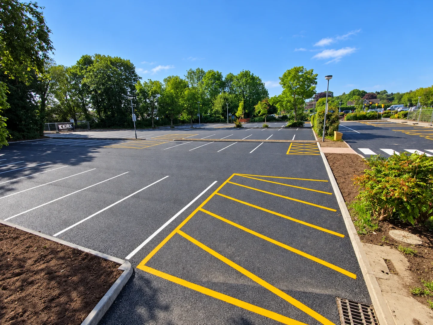 Completed KCC car park with fresh surfacing, marked bays and landscaped surroundings
